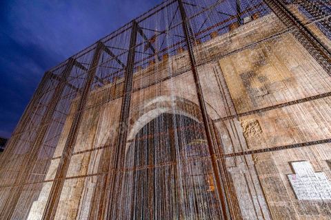 October 4, 2017: Dream City, the medina of Tunis. Works by Nidhal Chamekh. 
BARBED GATE installation: In the aftermath of January 14, 2011, security measures were tightened in the city of Tunis. What was previously announced as “exceptional measures” has become the norm. Barbed wire and other barriers are now part of the urban landscape.The decision to intervene at Bab El Bhar stems from the symbolic significance it has come to embody and the historical events that have shaped it into a border monument. Bab El Bhar is entirely covered in barbed wire, blurring the line between the controlled element and the tool of control. The imposing structure recedes, giving way to a ghostly silhouette that evokes the history of a gate opening onto the sea—renamed the Gate of France by the colonial authorities and now aligned with the axis of the statue of Ibn Khaldoun, that of Bourguiba, and the Obelisk.
