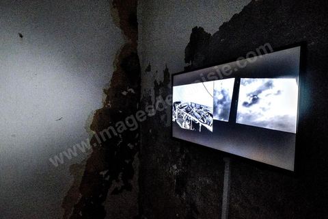 October 4, 2017: Dream City, Tunis Medina. Video installation by 
Fakhri el Ghezal titled “Héni éltéli”: “Wherever it falls, Fakhri El Ghezal’s gaze lends its solitude to more than one image. This video project unfolds, from one screen to the next, like so many variations on a single theme: drawing from everyday life, the videographer has decided to explore, day by day and without giving it too much thought, the realms of the intimate and the fictional. Armed with his cell phone, he captures—in varying durations—what passes by, comes to be, and unravels before his eyes. Between the routine and the isolation to which his well-oiled routine confines him; between death, which suddenly intrudes upon this daily life, and the grieving process that begins, certain threads of the artist’s post-prison experience replay in a loop. Bathed in black and white that yields as much to the present as to memory, Fakhri El Ghezal’s video work invites the viewer to keep their “third eye” open.”