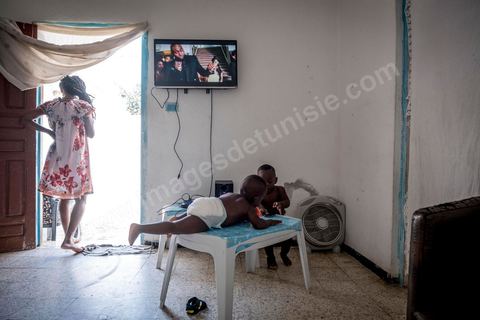 24 juin 2017 : Chez Océane, migrante Ivoirienne à Tunis dans un quartier populaire. Elle vit dans une maison avec 2 chambres qu'elle partage avec son fils Eden et cinq autres ivoiriennes. Océane est arrivée en Tunisie en 2010 comme étudiante et est depuis 5 ans en situation irrégulière, ne lui permettant plus de travailler légalement. Il y a deux ans Eden est né, ce jeune garçon plein de joie est devenu sa raison de vivre, elle souhaite trouver un endroit pour vivre normalement et élever son fils. “J’estime que pour vivre bien Tunisie, il me faudrait entre 800 et 1000 dinars. Généralement, je suis plutôt à 350. Entre les couches et la nourriture, les dépenses sont rapides.” La jeune femme travaille de façon irrégulière : elle a quelques patrons qui l’appellent, selon leur besoin, pour faire le ménage chez eux. Une journée lui rapporte entre 25 et 30 dinars.  