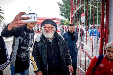 February 18, 2018: At Parc A, Club Africain’s training center, Mohamed Yacine Travelsi is a true star and one of CA’s oldest and most loyal fans. In Tunis, it’s the big day—the soccer derby, the match between the league’s two current top teams and Tunis’s two flagship clubs, Club Africain (CA) versus Espérance de Tunis (EST), at the Grand Stadium of Radès in the southern suburbs of Tunis. This rematch favors CA, which controls ticket sales. Given the numerous clashes between fans and ultra groups in the stadiums—both among themselves and with the police— only 23,000 tickets are being sold (out of a capacity of 60,000), including 1,200 for EST—though only about 50 of those will be in the south stand. The match will end with a surprise 2–1 victory for CA. 