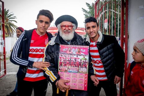 February 18, 2018: At Parc A, Club Africain’s training center, Mohamed Yacine Travelsi is a true star and one of CA’s oldest and most loyal fans. In Tunis, it’s the big day—the soccer derby, the match between the league’s two current top teams and Tunis’s two flagship clubs, Club Africain (CA) versus Espérance de Tunis (EST), at the Grand Stadium of Radès in the southern suburbs of Tunis. This rematch favors CA, which controls ticket sales. Given the numerous clashes between fans and ultra groups in the stadiums—both among themselves and with the police— only 23,000 tickets are being sold (out of a capacity of 60,000), including 1,200 for EST—though only about 50 of those will be in the south stand. The match will end with a surprise 2–1 victory for CA. 