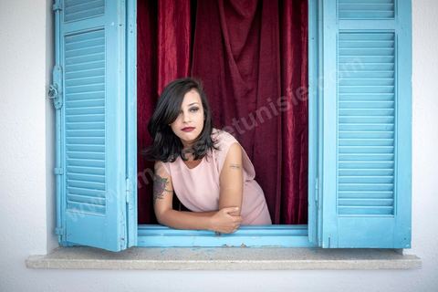 July 12, 2020: Profile of Emna Charki, a young Tunisian blogger facing legal charges for a Facebook post deemed to constitute “incitement to hatred between religions and a call for discrimination”; she faces up to three years in prison, with the verdict set for July 13. Here in her apartment while she’s in the process of moving—her landlord refusing to house a “kafir” (“unbeliever”)—she proudly displays her 2012 tattoo that reads “out law” (“outlaw”). On July 14, she was sentenced to six months in prison without parole for inciting hatred between religions and fined 2,000 dinars (€620) for desecration of the sacred. Her lawyers have filed an appeal. 