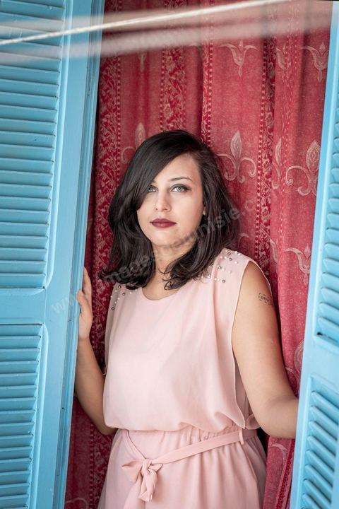 July 12, 2020: Profile of Emna Charki, a young Tunisian blogger facing legal charges for a Facebook post deemed to constitute “incitement to hatred between religions and a call for discrimination”; she faces up to three years in prison, with the verdict set for July 13. Here in her apartment while she’s in the process of moving—her landlord refusing to house a “kafir” (“unbeliever”)—she proudly displays her 2012 tattoo that reads “out law” (“outlaw”). On July 14, she was sentenced to six months in prison without parole for inciting hatred between religions and fined 2,000 dinars (€620) for desecration of the sacred. Her lawyers have filed an appeal. 