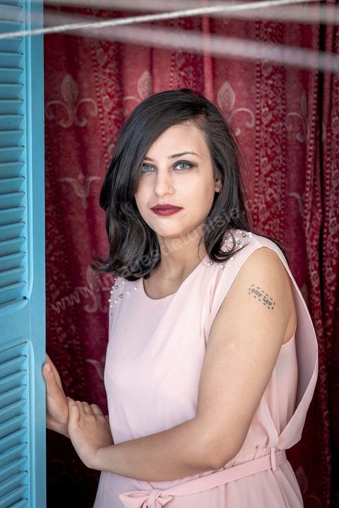 July 12, 2020: Profile of Emna Charki, a young Tunisian blogger facing legal charges for a Facebook post deemed to constitute “incitement to hatred between religions and a call for discrimination”; she faces up to three years in prison, with the verdict set for July 13. Here in her apartment while she’s in the process of moving—her landlord refusing to house a “kafir” (“unbeliever”)—she proudly displays her 2012 tattoo that reads “out law” (“outlaw”). On July 14, she was sentenced to six months in prison without parole for inciting hatred between religions and fined 2,000 dinars (€620) for desecration of the sacred. Her lawyers have filed an appeal. 