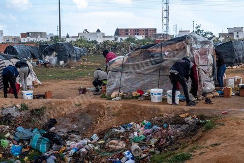 21 février 2024 :  ce camp de migrants sub saharien en périphérie de la ville de Jebeniana, au nord de Sfax, compte près de 300 hommes, femmes et enfants. Chassés de leur domicile il y a un an suite aux déclarations du président de la république tunisienne Kais Saied, les migrants par milliers sont rejetés dans la rue et les campagnes par les autorités locales, risquant à tout moment d'être arrétés et rénvoyés aux frontières libyennes ou algériennes. Ces camps improvisés sur des terrains vagues ou dans les champs sont abandonnés des ONG internationales.