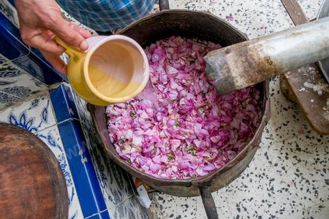 Distillation traditionnelle de fleurs de rose dans maison de la région de Nabeul au Cap Bon. L'eau et l'essence de rose proviennent de la distillation des fleurs de rose. La distillation est conduite très doucement sur le feu, l'hydrolat coule dans des Marie-Jeannes en verre. Le distillat coule légèrement tiède. 1 kg de pétale produit environ 1,5 litres d'eau de roses.