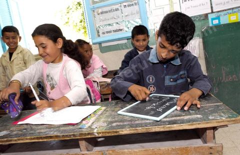 Ecole primaire à Houmt Souk sur l'île de Djerba - ecoliers dans leur école primaire, salle de classe, cour de récréation, écoliers en blouse rose et bleu, instituteur, cours de classe de primaire en Tunisie. enfants dasns sale de classe d'une école