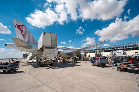 Chargement des bagages. Avion de Tunisair sur le tarmac de l'Aéroport international d'Enfidha Zine El Abidine Ben Ali