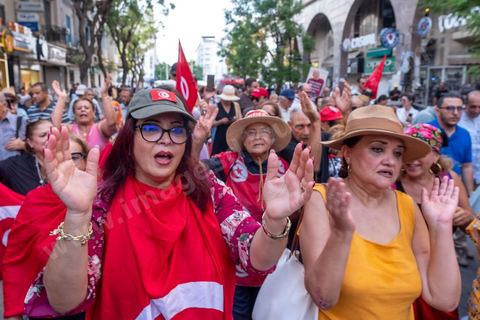 Tunis, Tunisie – 20 août 2026. Des manifestants défilent dans le centre de Tunis contre le président Kaïs Saïed, appelant à son départ et réclamant davantage de libertés politiques et la libération de détenus et opposants. Portraits du président barrés du slogan « DÉGAGE », drapeaux tunisiens et pancartes accompagnent la manifestation. La mobilisation intervient dans un contexte de mécontentement social croissant après plusieurs semaines de fortes chaleurs, de coupures d’eau et d’électricité et de difficultés d’accès à certains médicaments et produits essentiels.