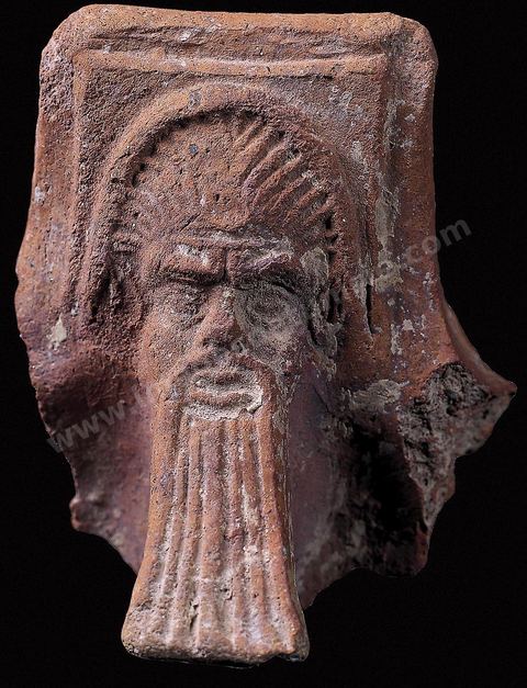 A brazier handle depicting a head adorned with a beard (Carthage Museum).