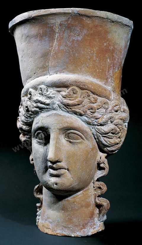 Head of Demeter Kernophoros with regular features, surmounted by a tall, hollow-inside polos (H. 35 cm, Sanctuary of Salammbô, Carthage, mid-2nd century BCE, Carthage Museum).