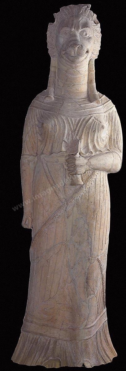 Déesse léontocéphale en terre cuite représentant Tanit, identifiée grâce à une monnaie romaine datant de 46 av.‑J.-C., où elle figure accompagnée des initiales G.T.A. ( Genius Terrae Africae, génie de la terre d’Afrique ). Personnifiant l’Afrique et régissant son destin, elle était d’autant plus habilitée à adopter la tête léonine que le roi des animaux et des forces de la nature a toujours été l’un des symboles essentiels du continent ( H. 150‑cm, l.46‑cm, ép. 36 cm, sanctuaire de Thinissut , près de Bir Bouregba, Ier‑siècle ap. J.-C., musée du Bardo). Section numide - musée du Bardo